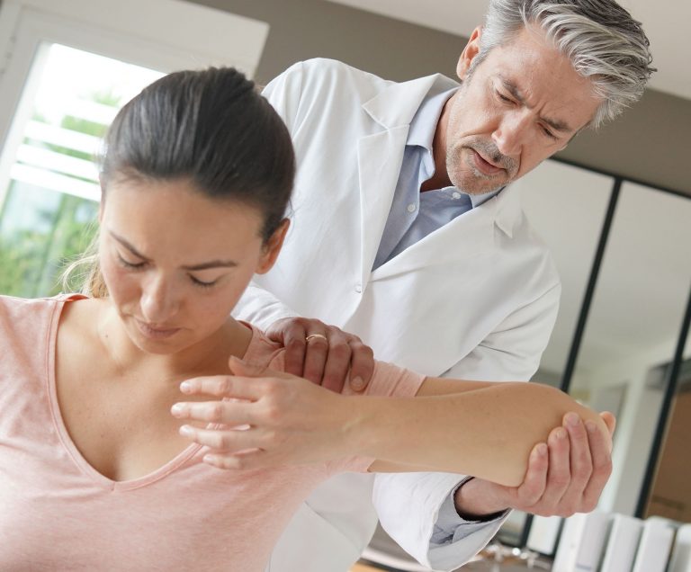Doctor examines patient with musculoskeletal disorder, healthcare and medical professional