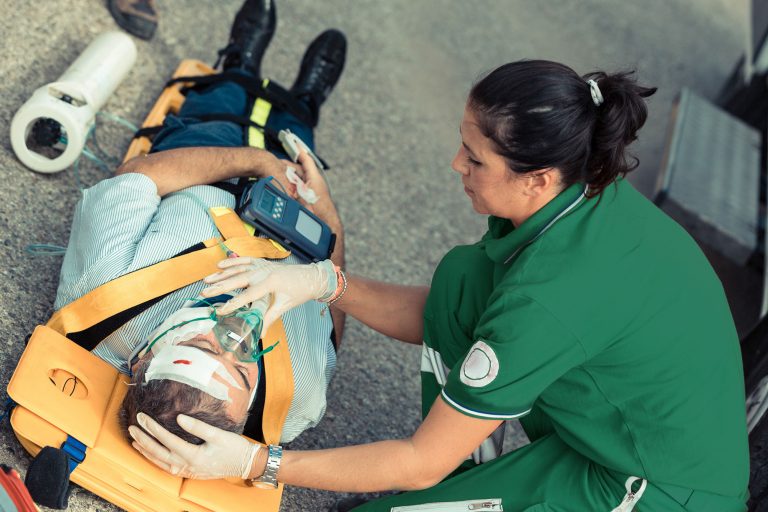 Paramedic saving a life after an accident, healthcare and medical workers